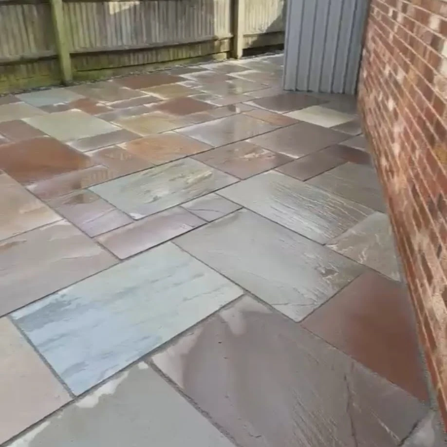 Block paved patio with grey gate.