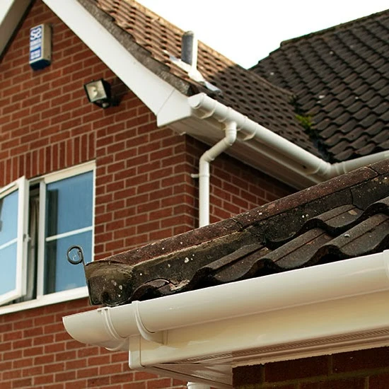 Brick house with white facias and guttering.