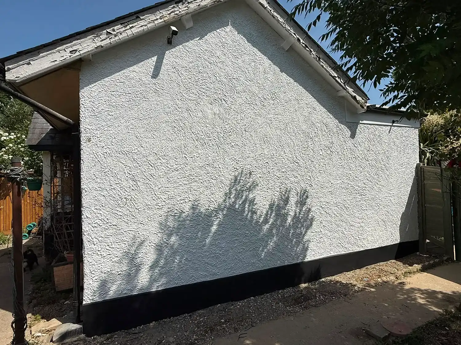 White side of a house after cleaning.