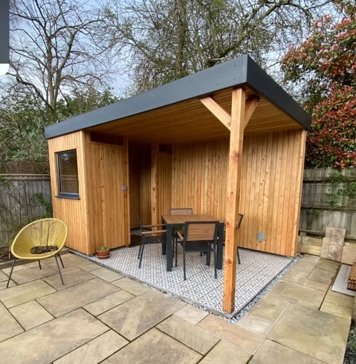 Wooden structure with table, chairsand roof.
