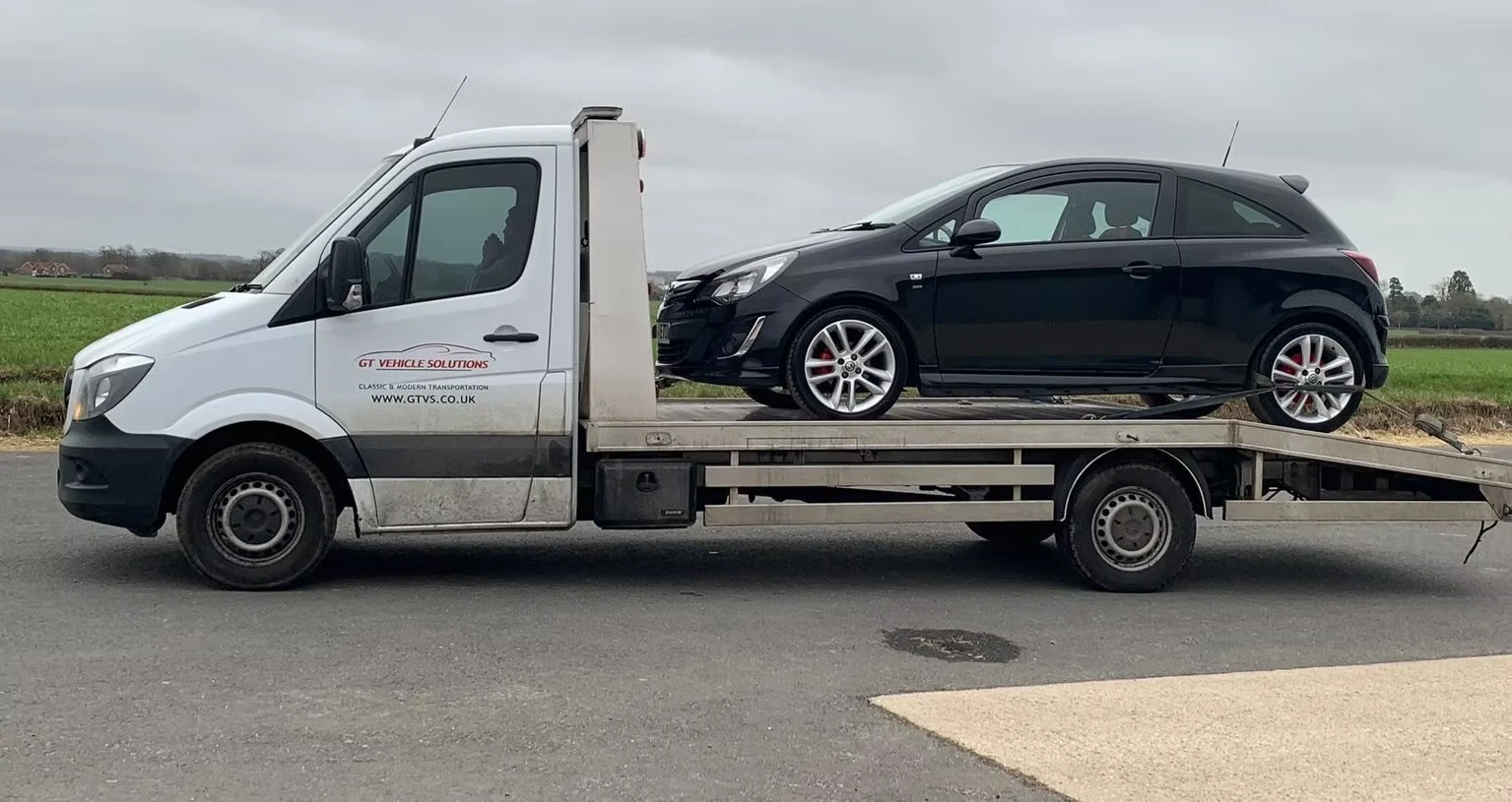 Broken down Vauxhall Corsa on the back of a lorry.