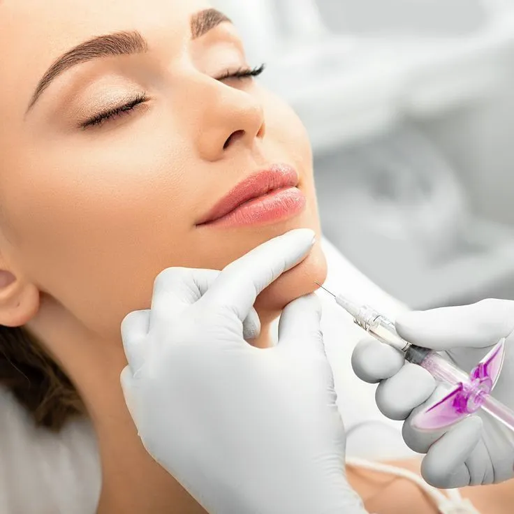 A woman getting botilage injections on her face.