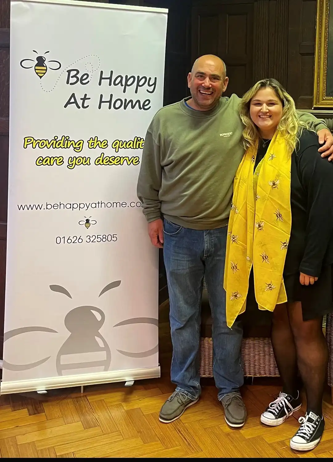 two people standing in front of a sign