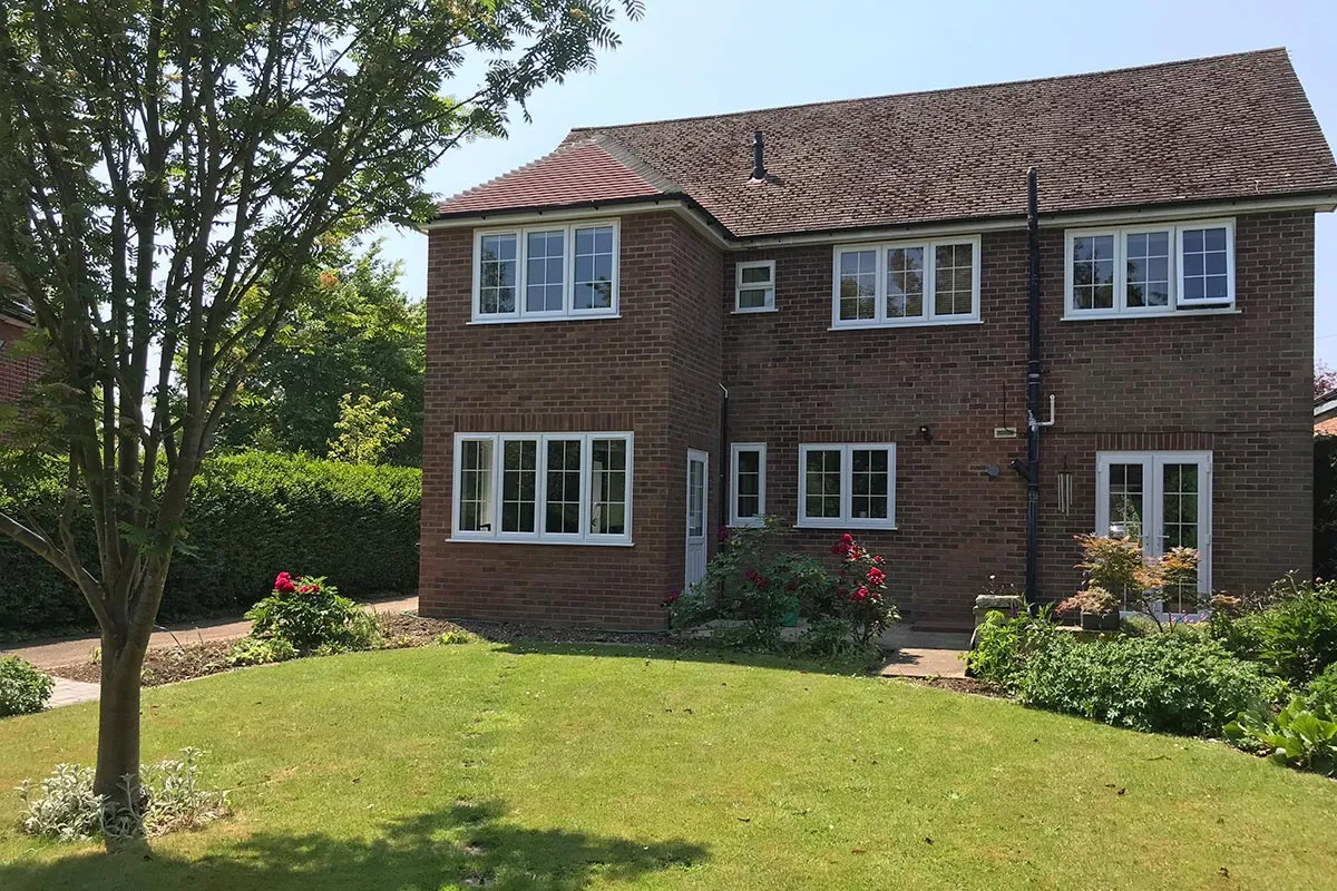 a large brick house with a tree in front of it