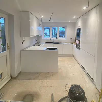 A kitchen with a sink and a stove top oven.