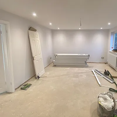 A room that is being remodeled with a ladder.