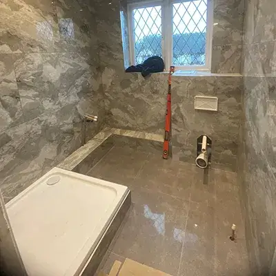 A bathroom with a tub and a window.