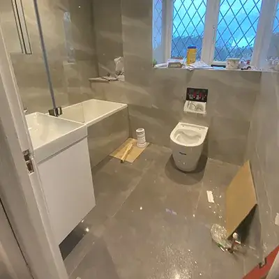 A bathroom with a toilet and a sink in it.