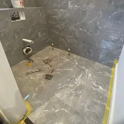 A bathroom with a shower and a toilet in it.