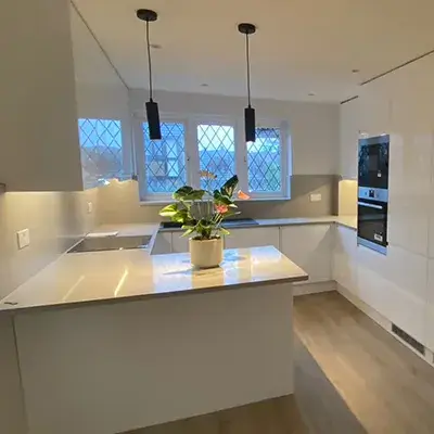 A kitchen with a center island and a stove.