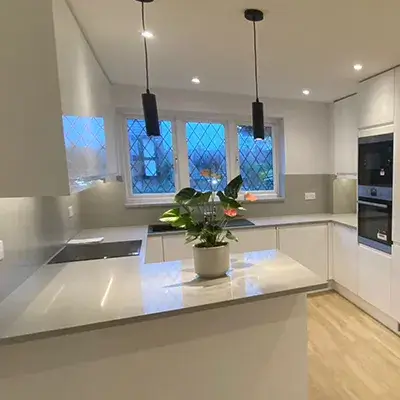 A kitchen with a center island and a stove.