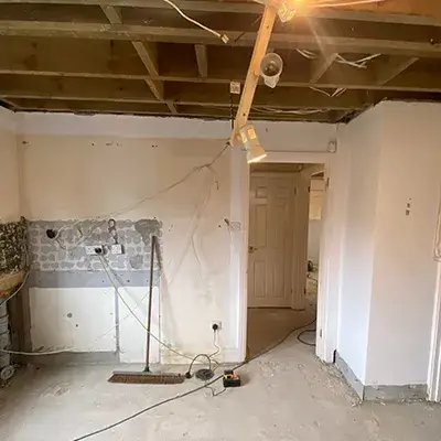 A room that is being remodeled with a ceiling fan.