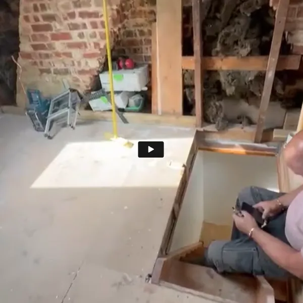 A man sitting in a room under construction.