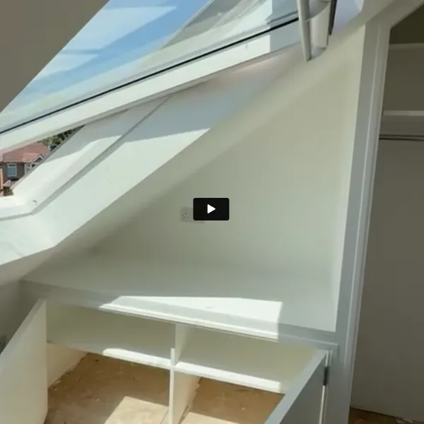A white shelf under a window with a skylight.