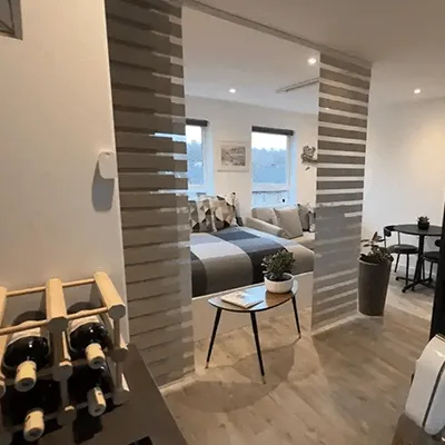 A living room filled with furniture and a wine rack.