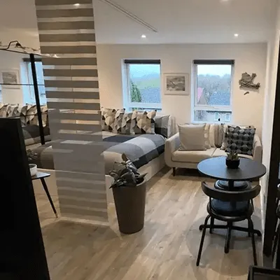 A living room filled with furniture and a staircase.