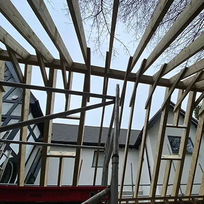 A house being built with wooden framing.