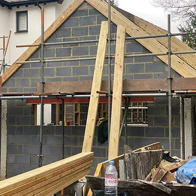 A house being built with wooden framing.