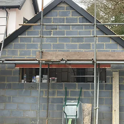 A house under construction with scaffolding around it.