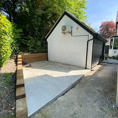 A small white house sitting in the middle of a yard.