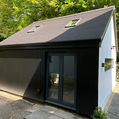 A black and white house with a black roof.