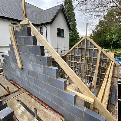 A house being built with a brick wall.