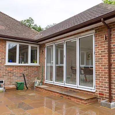 A brick house with a patio and patio furniture.