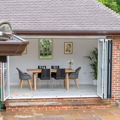 A patio with a table and chairs in it.