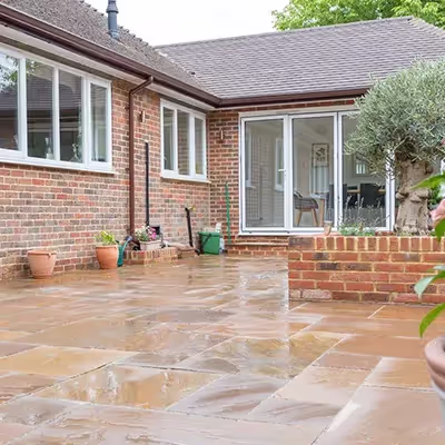 A brick house with a potted plant in front of it.