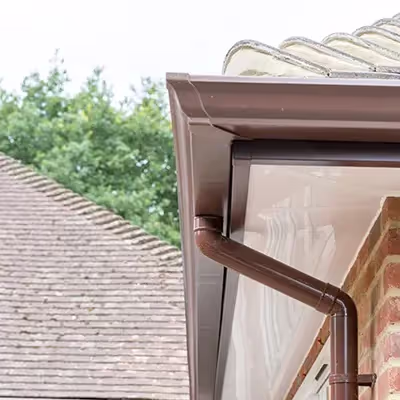 A close up of a gutter hose attached to a roof.