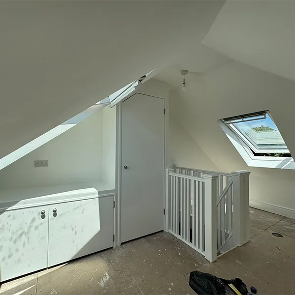 A room with a crib and a window in it.