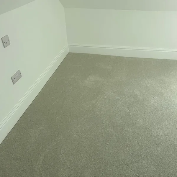 A corner of a room with a light switch.