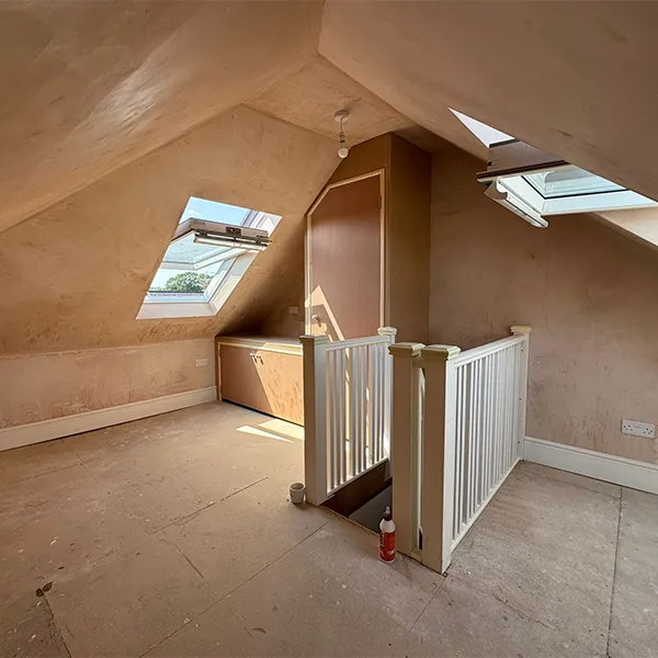 A room with a staircase and a skylight in it.