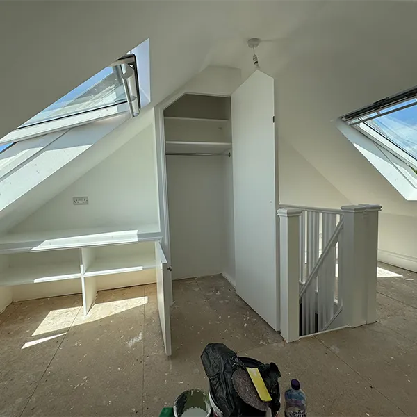 A room with a skylight and a closet in it.