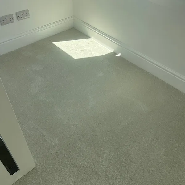 An empty room with a door and a window.