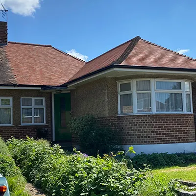 A house with a car parked in front of it.