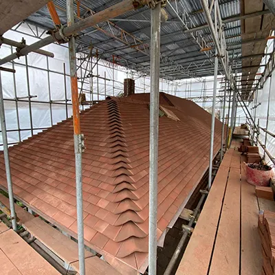 The roof of a building with scaffolding around it.