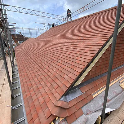 A man standing on top of a roof.