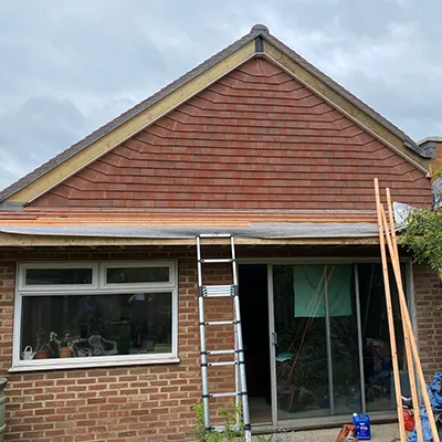 A house being built with a ladder in front of it.