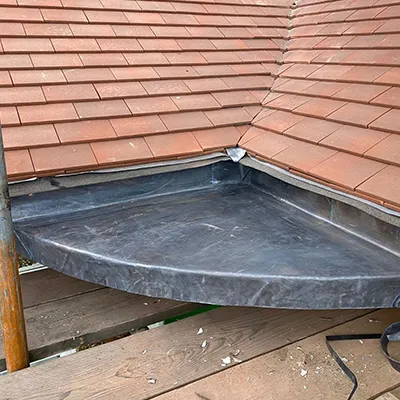 A metal tray sitting on top of a wooden deck.