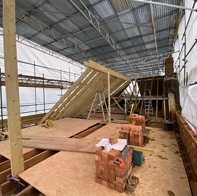 A building under construction with a metal roof.