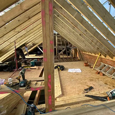 A room with a roof that is being built.