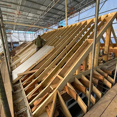 A large wooden structure under a metal roof.