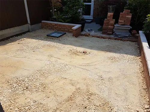 a backyard with a graveled area and a fire hydrant