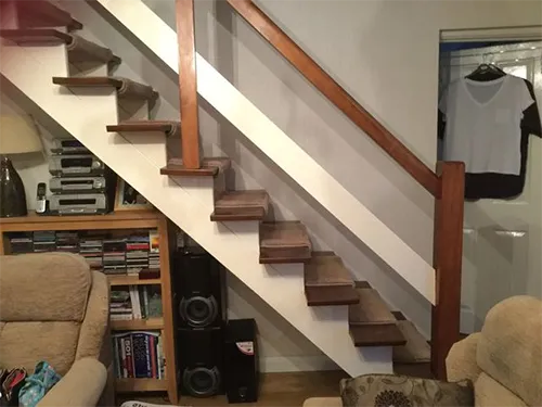 a living room filled with furniture and a stair case