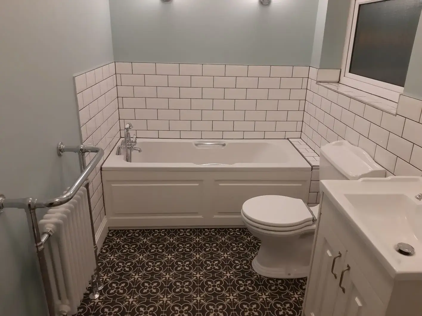 A white toilet sitting next to a bath tub.
