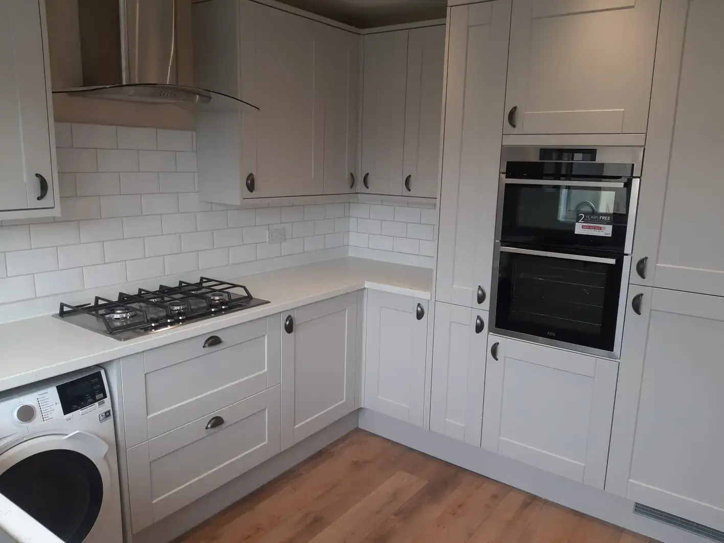 a kitchen with white cabinets and a stove top oven