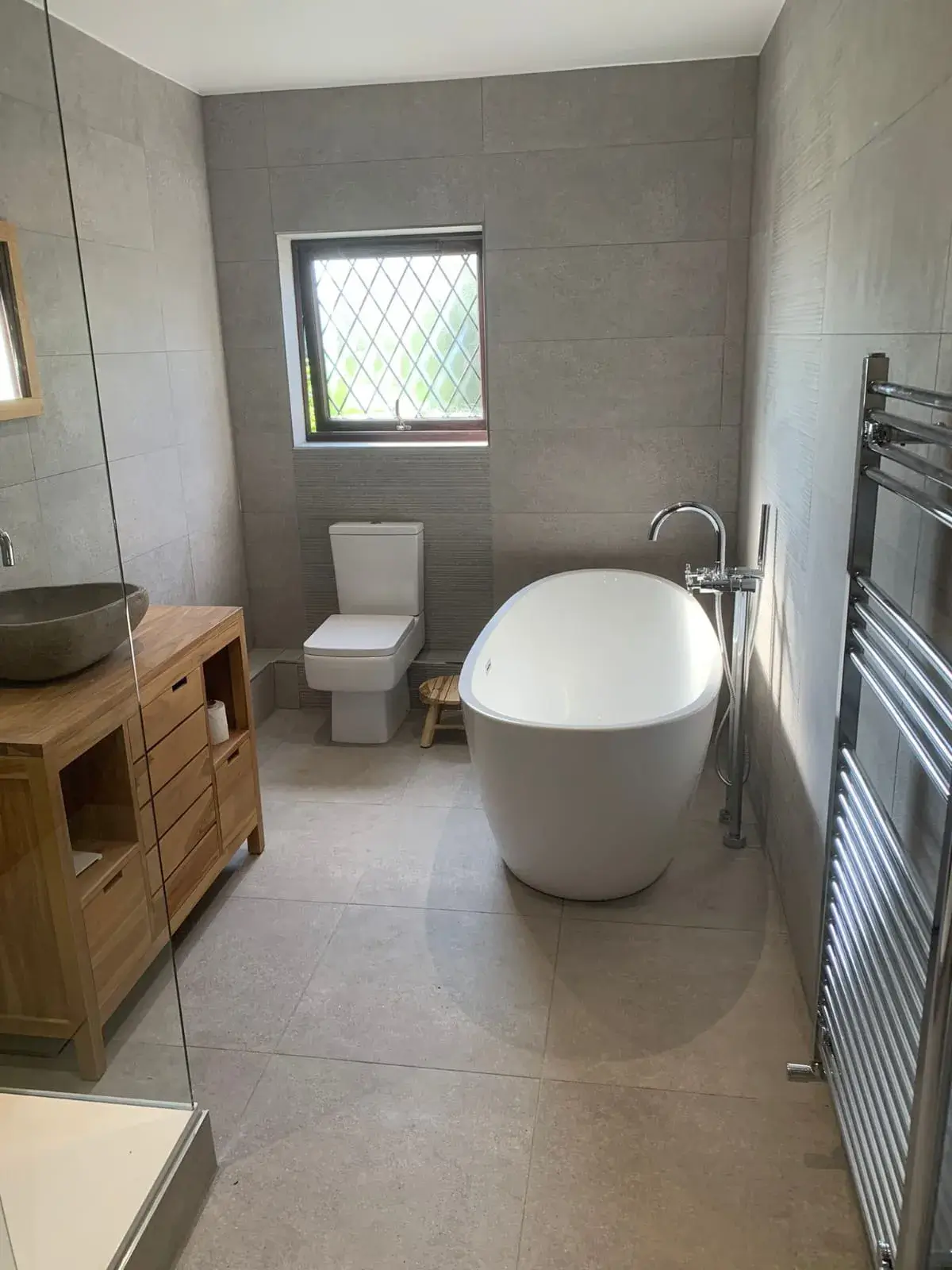 a bath room with a toilet a bath tub and a sink