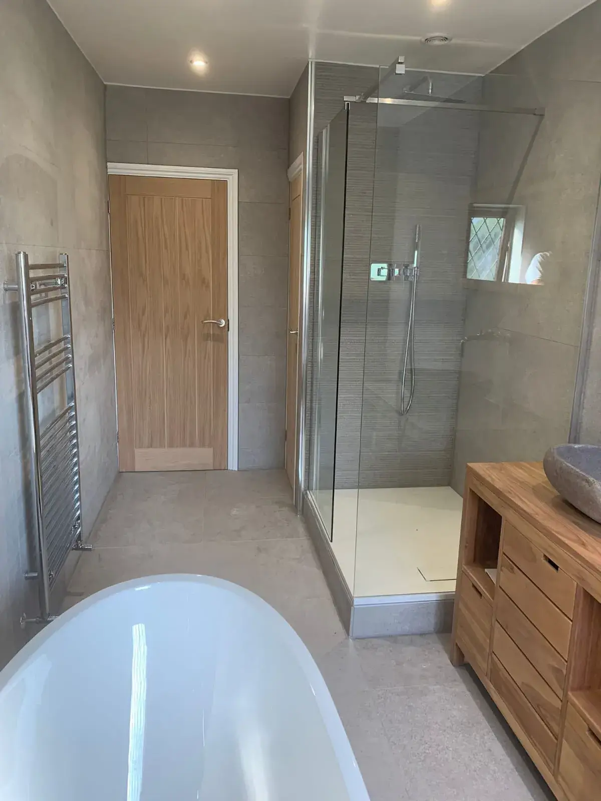 a bathroom with a tub, sink, and shower