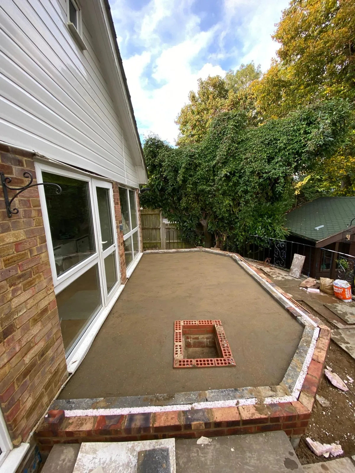A patio with a brick border around it.